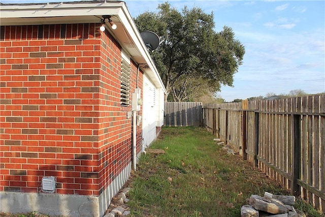 4125 Rapids Dr, Corpus Christi, TX 78410 - view of side of home with brick siding and a fenced backyard