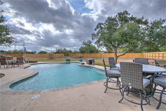 view of swimming pool with a patio area