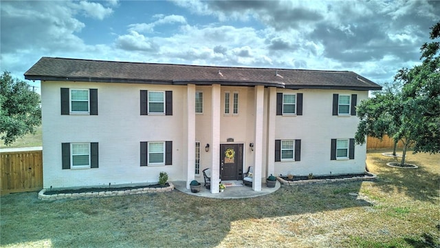 view of front of property with a patio and a front lawn