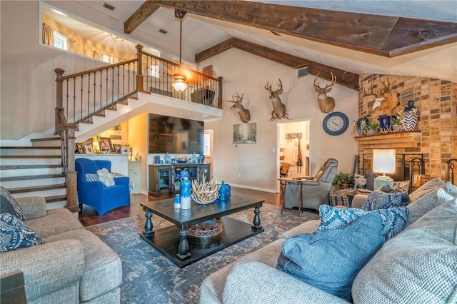 living room featuring hardwood / wood-style floors, beamed ceiling, and high vaulted ceiling