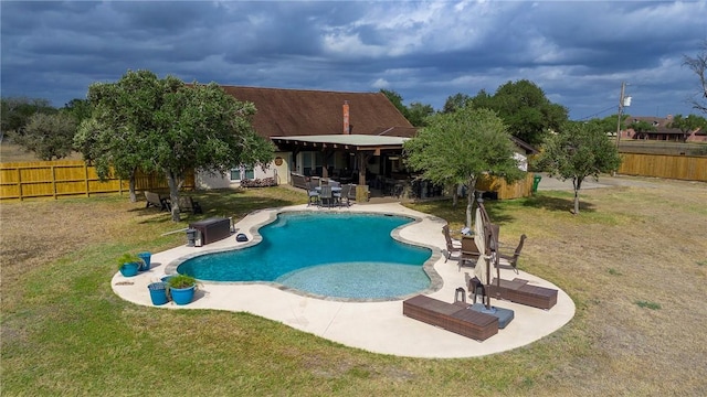 view of swimming pool featuring a patio area and a yard