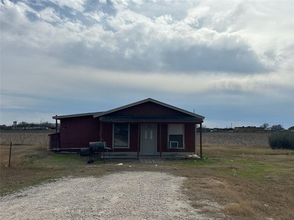 view of front of house with a rural view