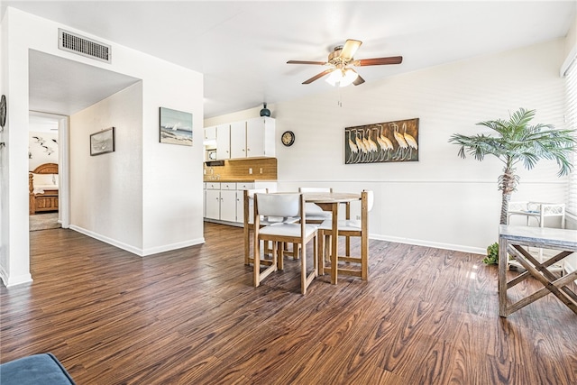 dining space featuring dark hardwood / wood-style flooring and ceiling fan