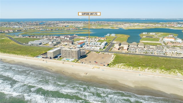 birds eye view of property featuring a water view and a view of the beach