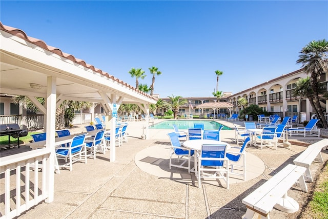 view of swimming pool with a patio area and area for grilling