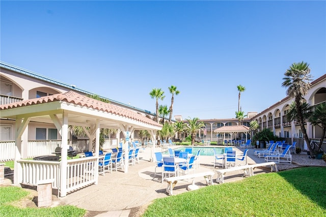 view of swimming pool with a patio area, a lawn, a gazebo, and grilling area