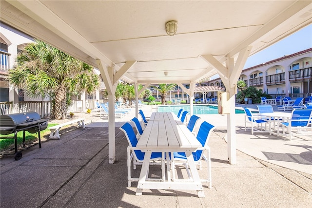 view of patio featuring grilling area and a community pool