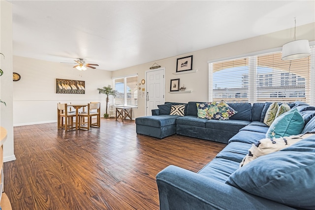 living room with dark hardwood / wood-style floors and ceiling fan