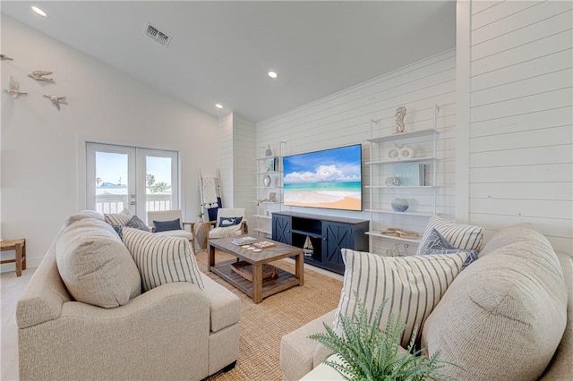 living room with french doors and high vaulted ceiling