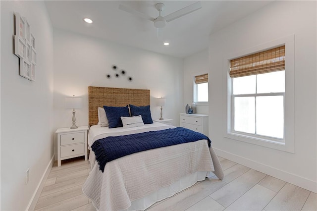 bedroom with ceiling fan and light hardwood / wood-style floors