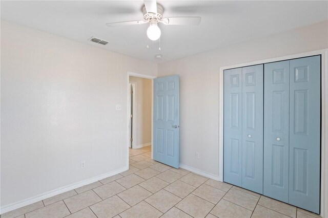 410 Knickerbocker St, Corpus Christi, TX 78418 - unfurnished bedroom with baseboards, light tile patterned flooring, a closet, and ceiling fan