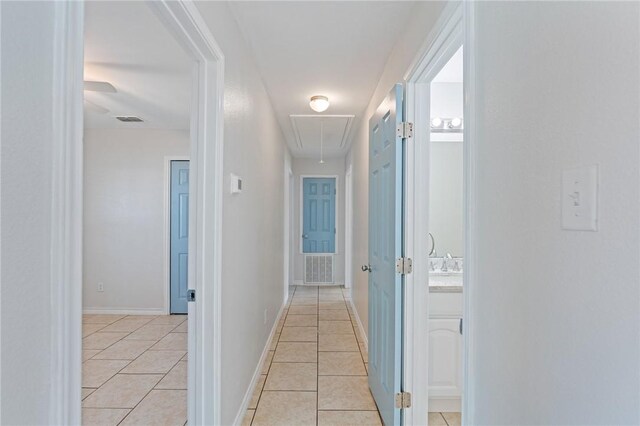 410 Knickerbocker St, Corpus Christi, TX 78418 - corridor featuring attic access, light tile patterned flooring, and baseboards