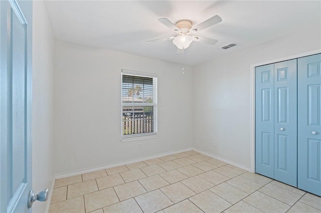410 Knickerbocker St, Corpus Christi, TX 78418 - unfurnished bedroom featuring a closet, light tile patterned floors, baseboards, and ceiling fan