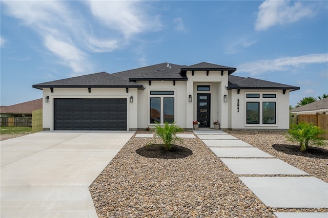 prairie-style home featuring a garage