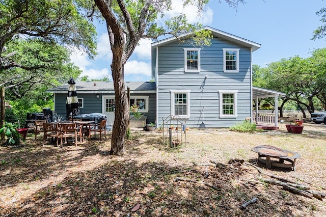 back of property featuring an outdoor fire pit