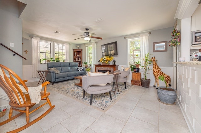 tiled living room with ceiling fan