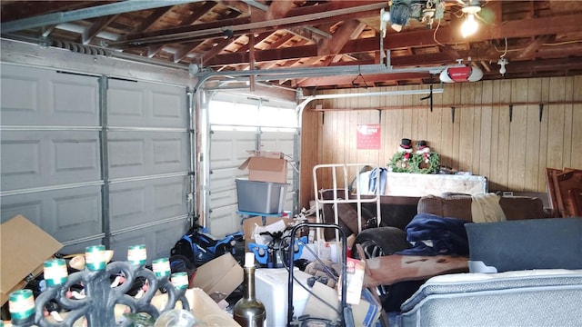 garage featuring wooden walls and a garage door opener