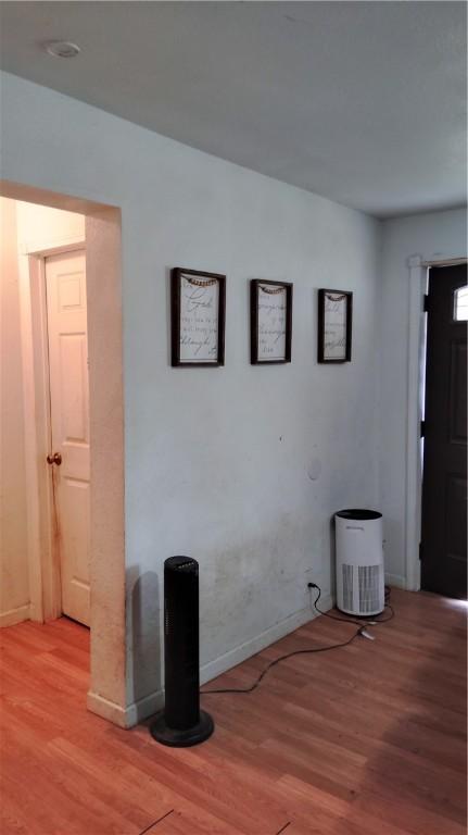 entrance foyer with baseboards and light wood finished floors