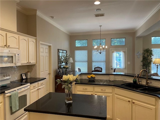 5413 Fisher Cir, Corpus Christi, TX 78413 - kitchen with white appliances, dark countertops, a chandelier, backsplash, and ornamental molding