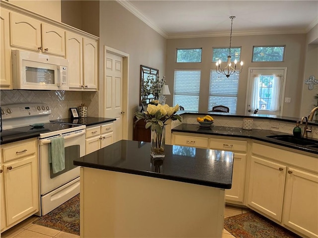 5413 Fisher Cir, Corpus Christi, TX 78413 - kitchen featuring white appliances, decorative backsplash, dark countertops, light tile patterned flooring, and crown molding