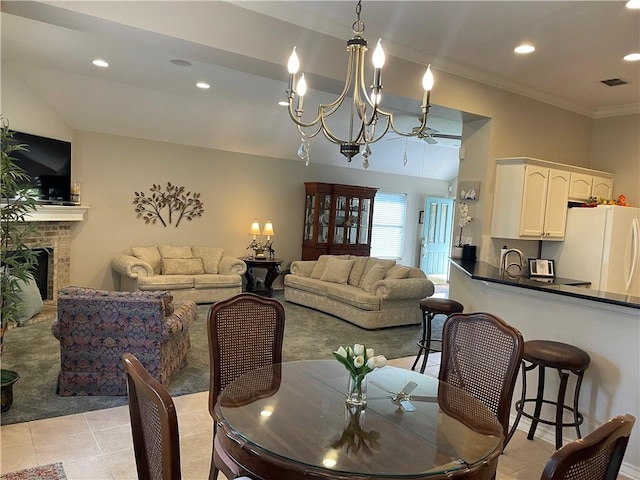 5413 Fisher Cir, Corpus Christi, TX 78413 - dining room featuring a chandelier, light tile patterned floors, a brick fireplace, ornamental molding, and recessed lighting