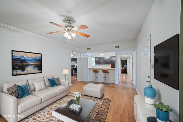 3730 Lincoln St, Corpus Christi, TX 78415 - living area featuring ceiling fan, light wood finished floors, and ornamental molding