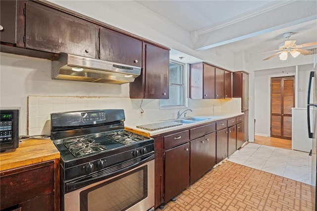 3730 Lincoln St, Corpus Christi, TX 78415 - kitchen with range with gas cooktop, under cabinet range hood, a ceiling fan, dark brown cabinetry, and ornamental molding