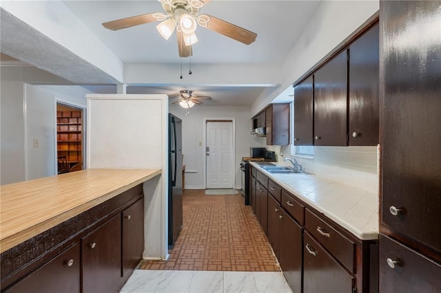 3730 Lincoln St, Corpus Christi, TX 78415 - kitchen with a ceiling fan, black appliances, dark brown cabinetry, and tile countertops