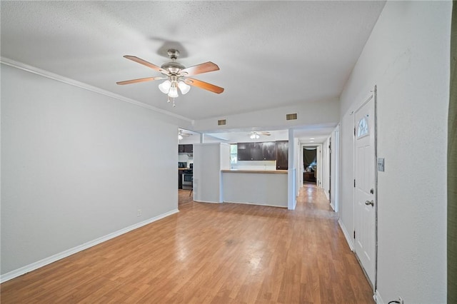 3730 Lincoln St, Corpus Christi, TX 78415 - unfurnished living room featuring a ceiling fan, light wood-style flooring, a textured ceiling, and ornamental molding