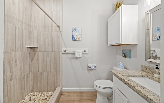 15101 Boca Grandi Dr, Corpus Christi, TX 78418 - bathroom featuring toilet, vanity, baseboards, and tiled shower