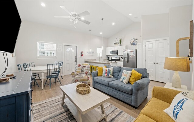 15101 Boca Grandi Dr, Corpus Christi, TX 78418 - living room with a ceiling fan, high vaulted ceiling, light wood finished floors, and recessed lighting