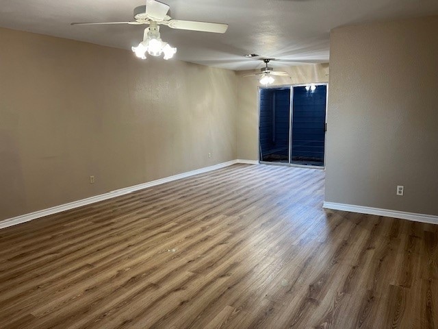 empty room featuring ceiling fan and wood-type flooring