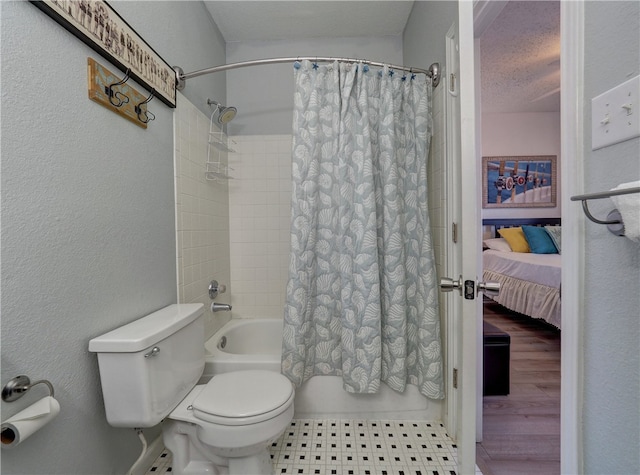 bathroom featuring hardwood / wood-style flooring, shower / tub combo with curtain, a textured ceiling, and toilet