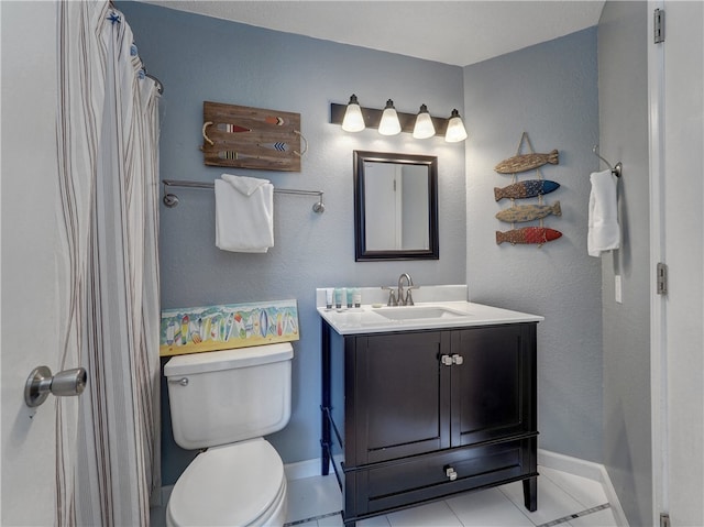 bathroom featuring toilet, vanity, and tile patterned floors