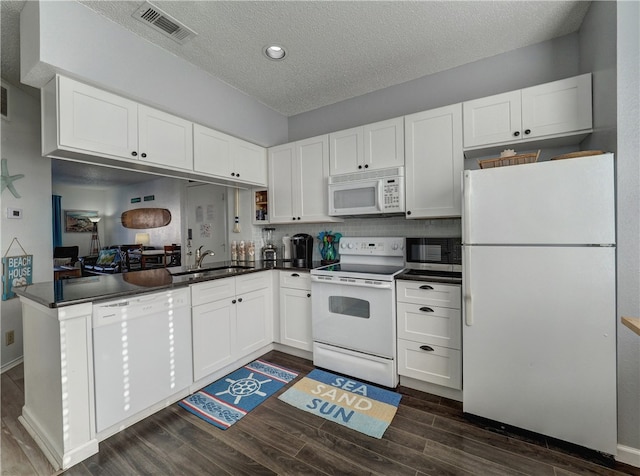 kitchen with white cabinetry, sink, white appliances, and dark hardwood / wood-style floors