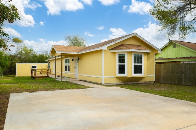 rear view of property with a lawn