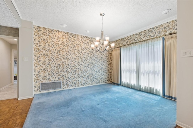 6031 Lost Creek Dr, Corpus Christi, TX 78413 - spare room featuring a textured ceiling, visible vents, ornamental molding, and an inviting chandelier