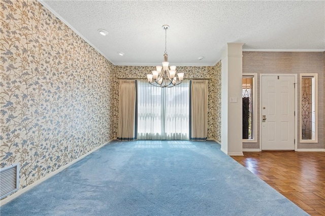 6031 Lost Creek Dr, Corpus Christi, TX 78413 - empty room featuring wallpapered walls, baseboards, an inviting chandelier, and ornamental molding