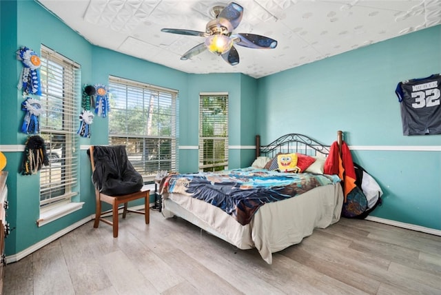 bedroom featuring ceiling fan and light hardwood / wood-style flooring