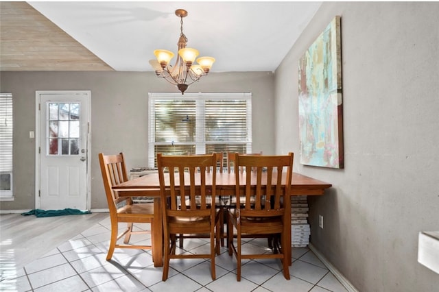 dining room with light tile patterned floors and a notable chandelier