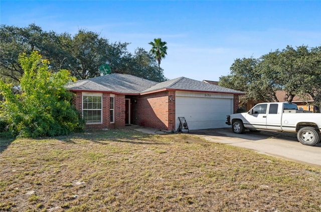 single story home featuring a front yard and a garage