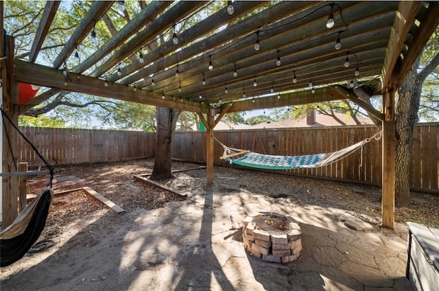 view of patio featuring a pergola and a fire pit