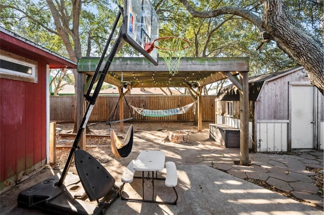 view of patio with a fire pit and a storage unit