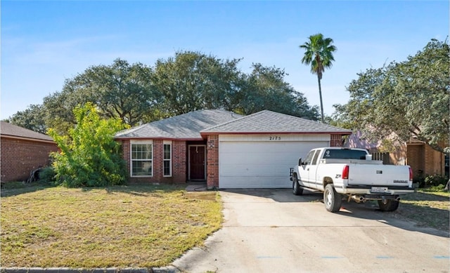 ranch-style house featuring a front yard and a garage