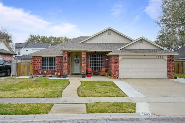 single story home featuring a front yard, fence, driveway, a garage, and brick siding