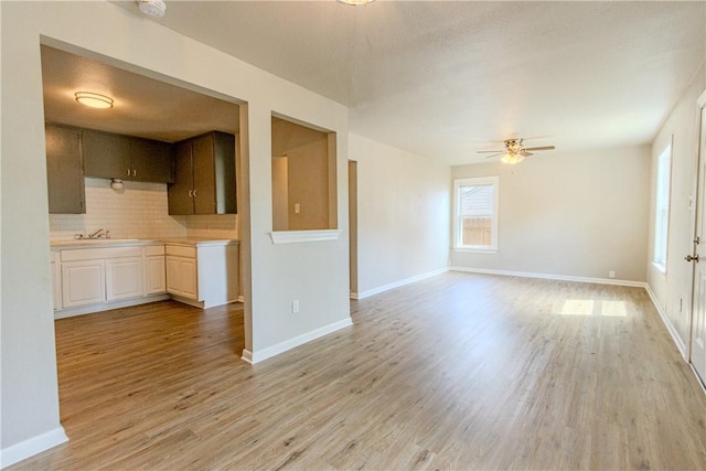 4338 Cottage St, Corpus Christi, TX 78415 - unfurnished living room with healthy amount of natural light, ceiling fan, light wood-style flooring, and baseboards