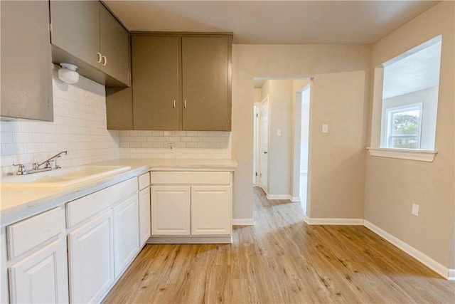 4338 Cottage St, Corpus Christi, TX 78415 - kitchen with a sink, tasteful backsplash, light wood-type flooring, light countertops, and baseboards