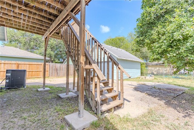 4338 Cottage St, Corpus Christi, TX 78415 - fenced backyard with stairs and central AC unit