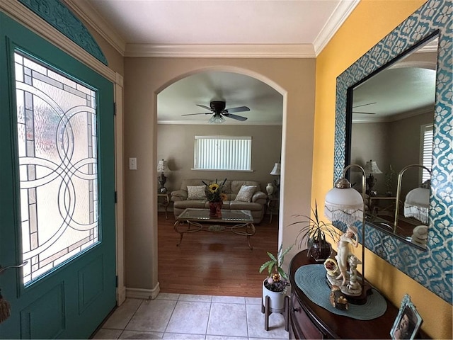 1645 W Manor Dr W, Corpus Christi, TX 78412 - entrance foyer featuring ceiling fan, ornamental molding, tile patterned flooring, and arched walkways