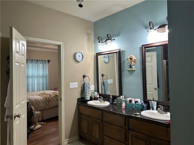 1645 W Manor Dr W, Corpus Christi, TX 78412 - bathroom with ensuite bath, double vanity, and wood finished floors